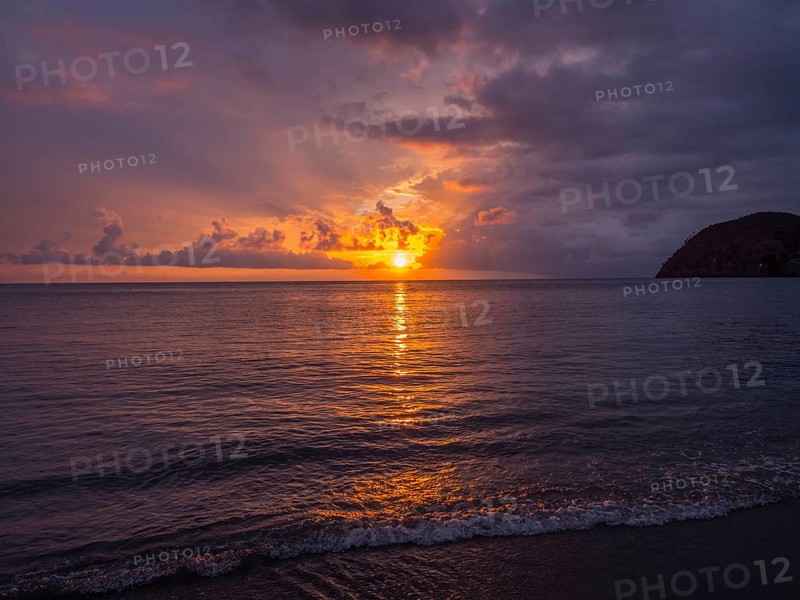 Sunset behind clouds over the sea