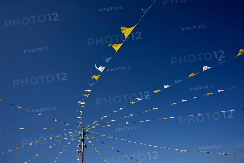 Colorful pennant against a blue sky at a festival