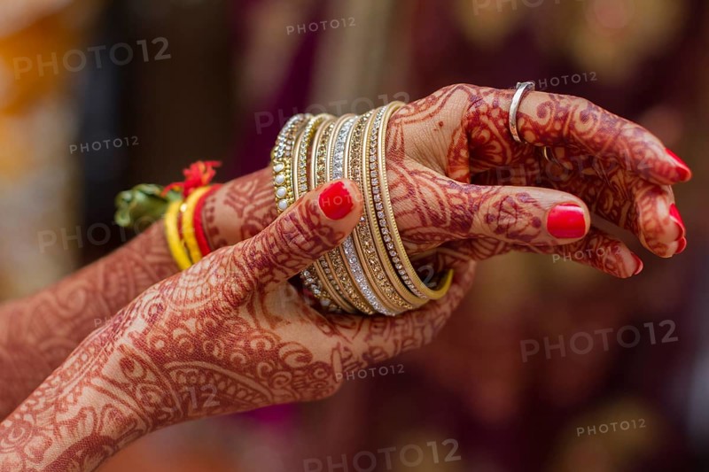 Hands of Indian bride hands painted with henna