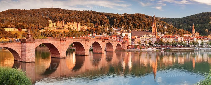 View of Karl Theodor Bridge and Gate over the Neckar River with castle in Heidelberg