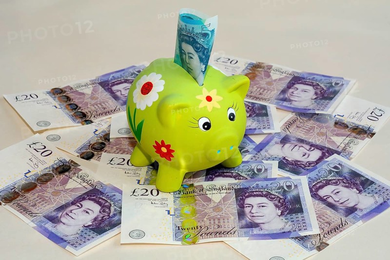 Piggy bank on twenty pound British banknotes