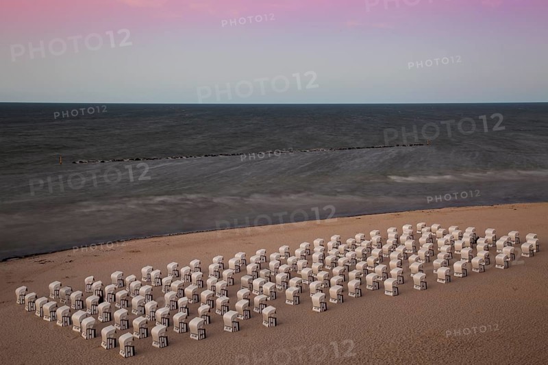 White beach chairs on the beach at twilight