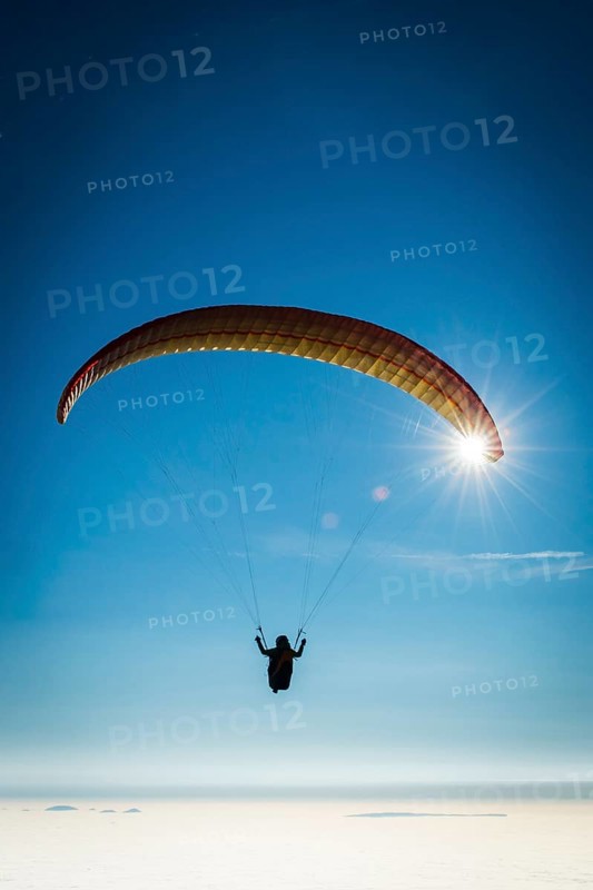Paraglider over cloud cover