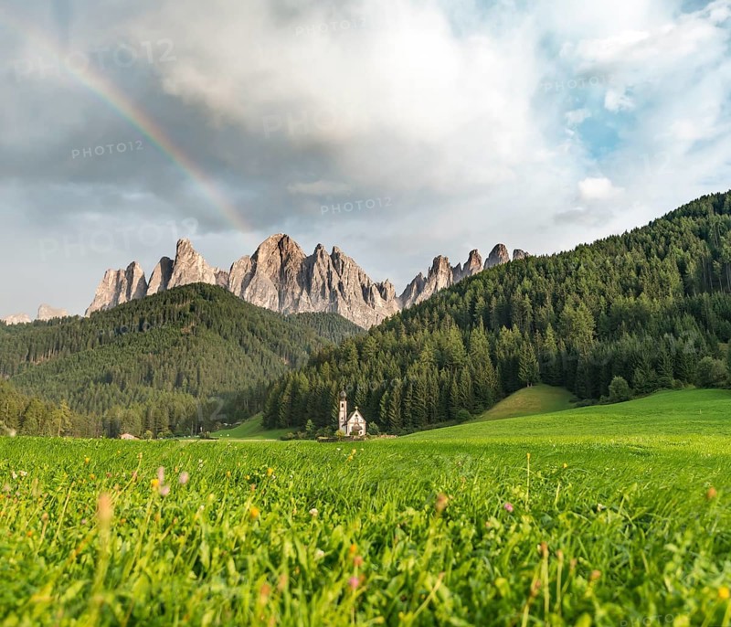 Rainbow in front of the church St. Johann in Ranui