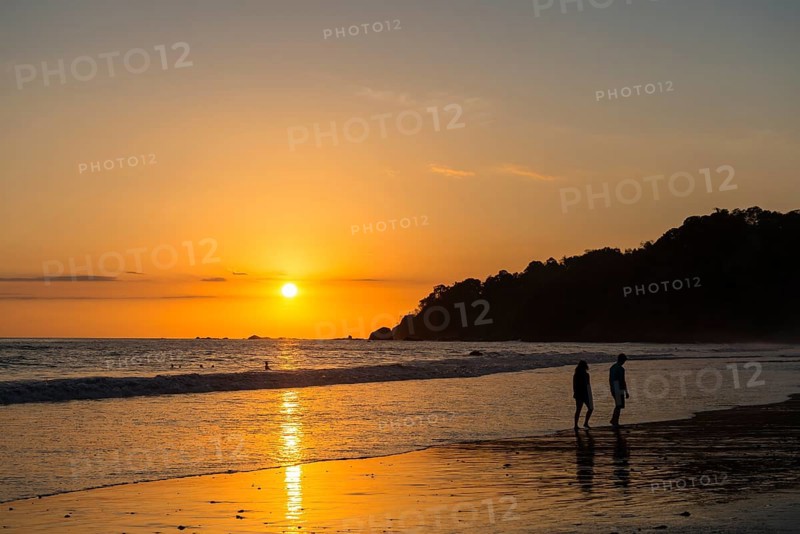 Man and woman strolling on the beach