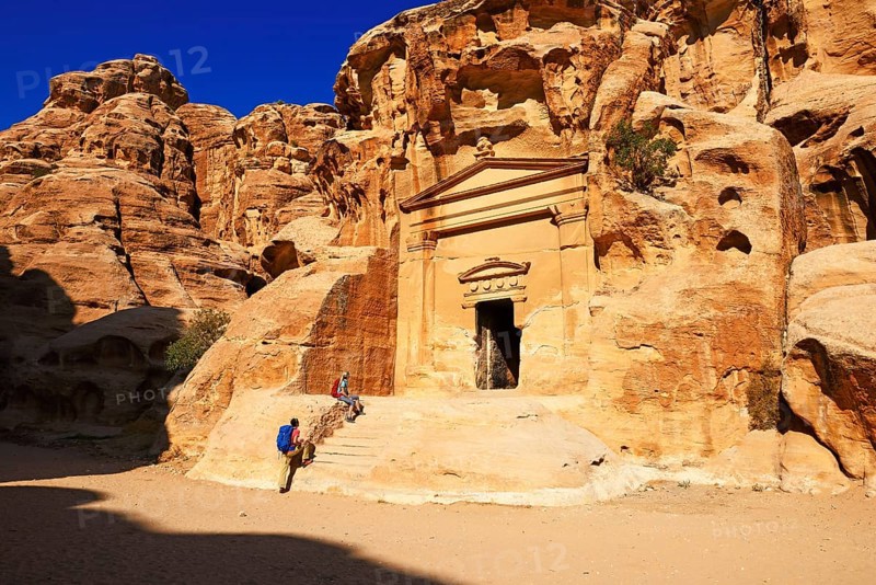 Hikers at rock-church in Little Petra