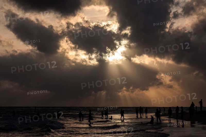 People in backlight on beach