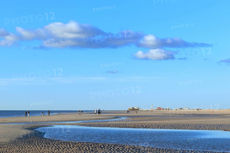 Sandy beach with walkers