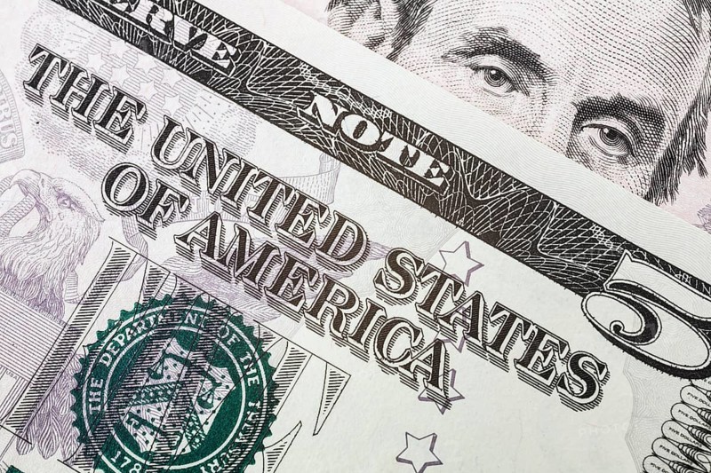 US five dollar bill and portrait of Abraham Lincoln
