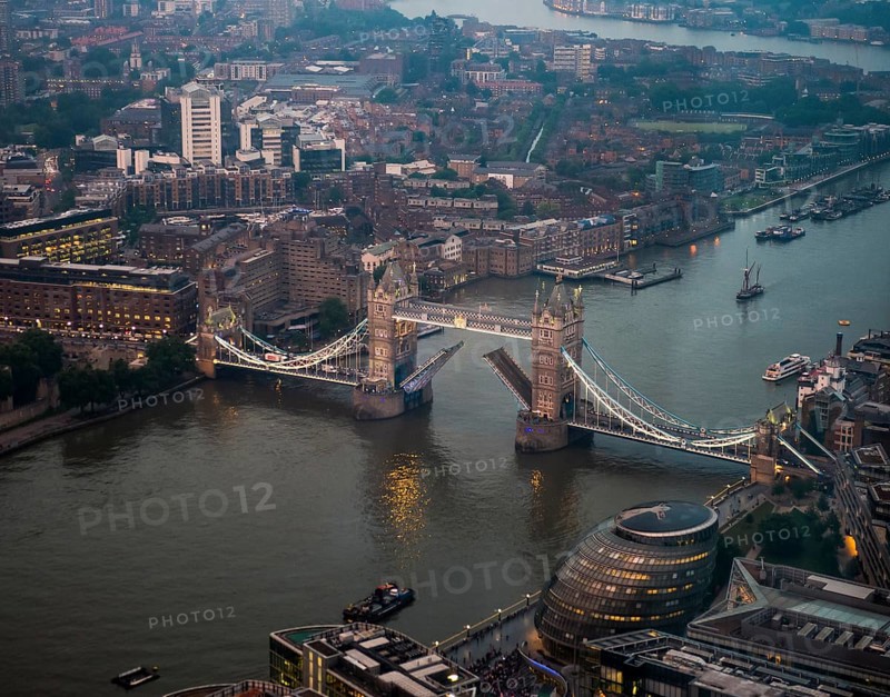View of opened and illuminated Tower Bridge across the River Thames