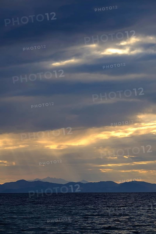 Thunderclouds at sunset on the beach