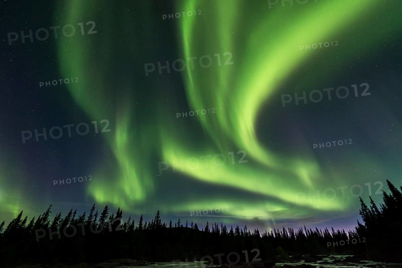 Northern Lights or Aurora Borealis above river Gamajahka or Kamajakka