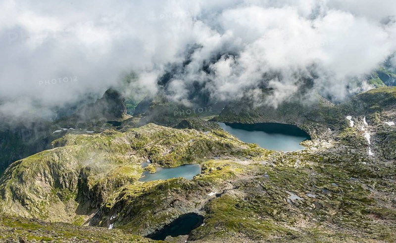 Clouds passing over a ridge with mountain lakes