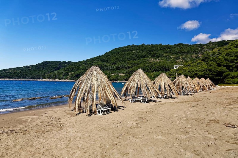 Sunshades at the sand beach at Saplunara