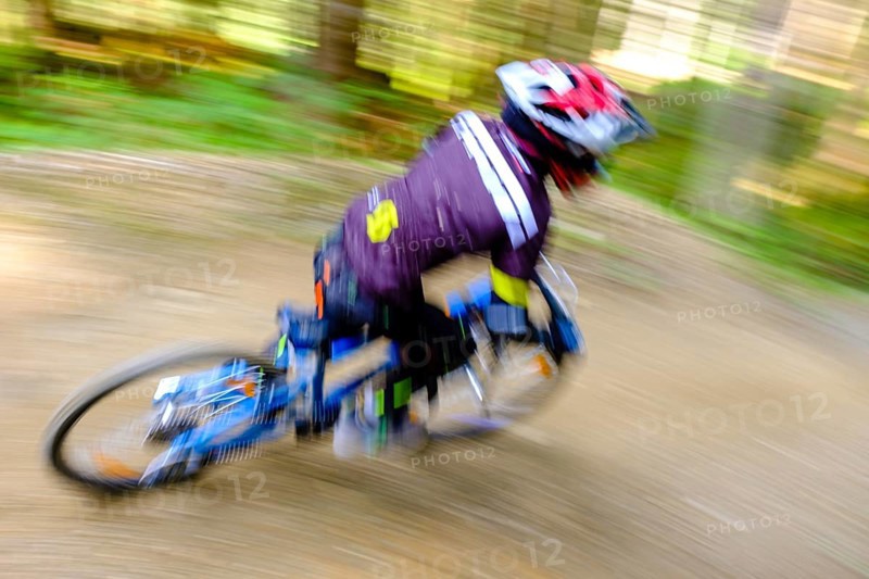 Child 9 years old rides on a mountain bike downhill