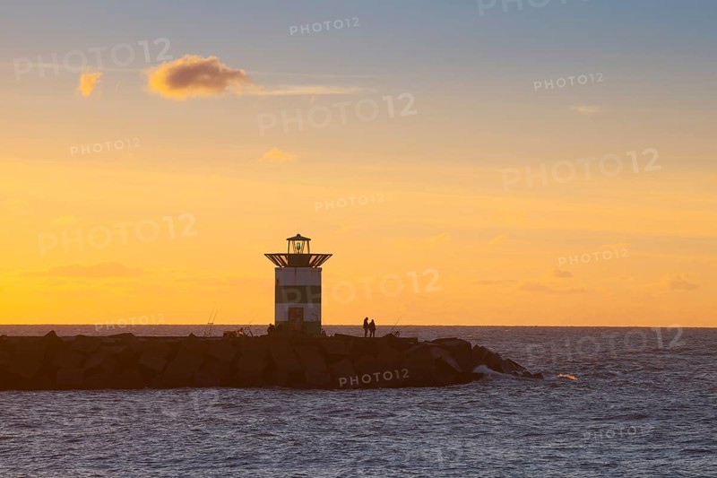 Small lighthouse at harbor entrance