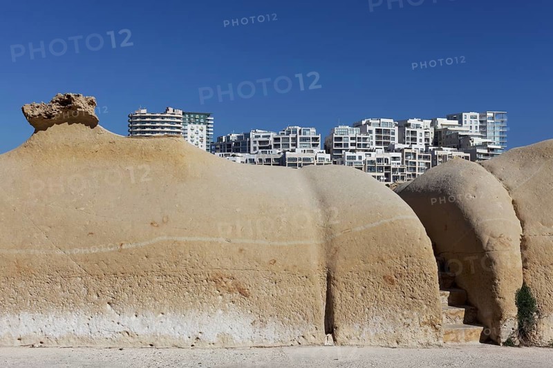 Ocher colored limestone sand formation at St. Elmo Bay from Valletta