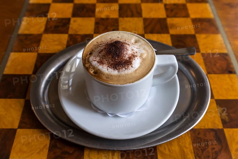 Cappuccino on table with chessboard pattern