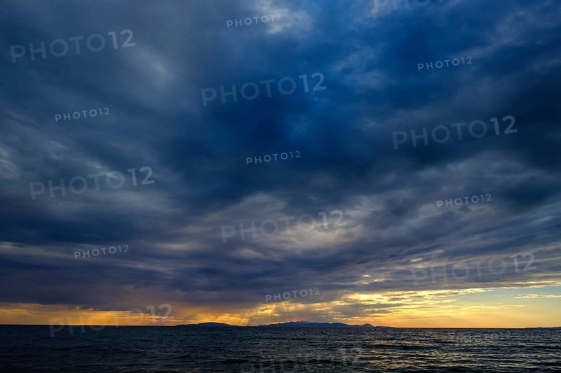 Thunderclouds at sunset on the beach
