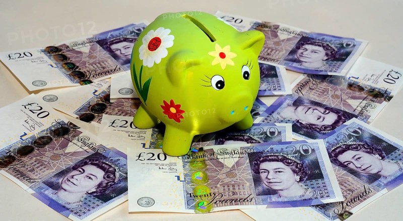 Piggy bank on twenty pound British banknotes