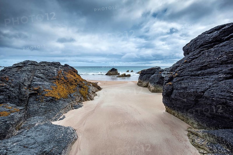 Rock with sandy beach in the bay of Sango Sands