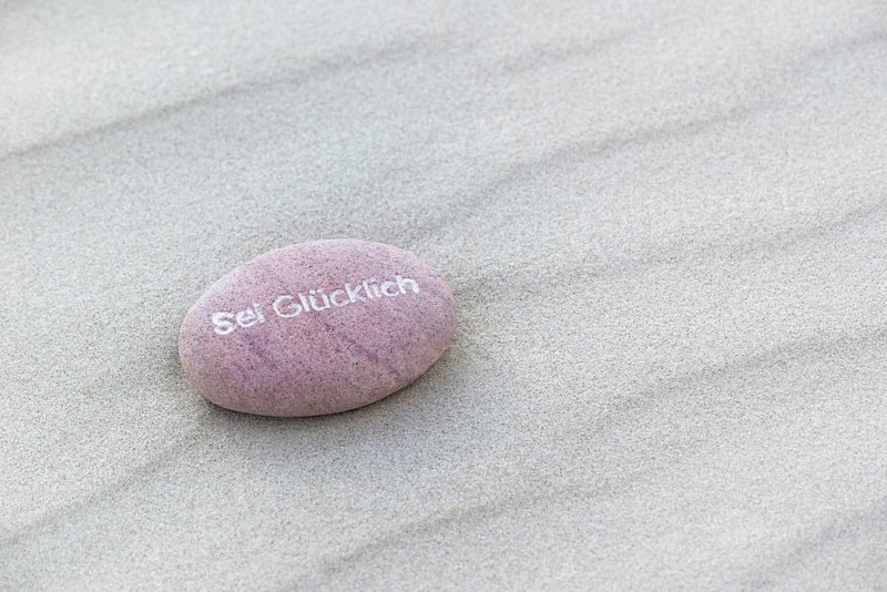 Be Happy inscribed in small stone