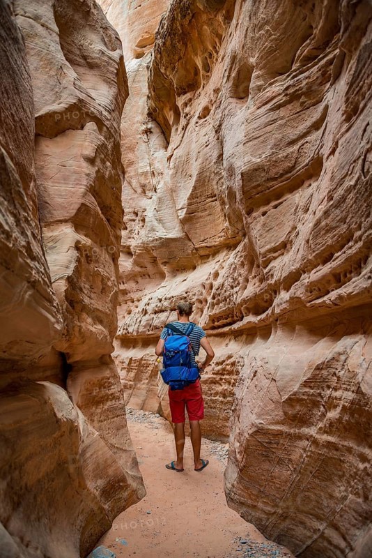 Young man standing in ravine of Slot Canyon