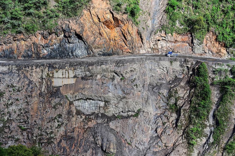 Narrow street in cliff with trucks