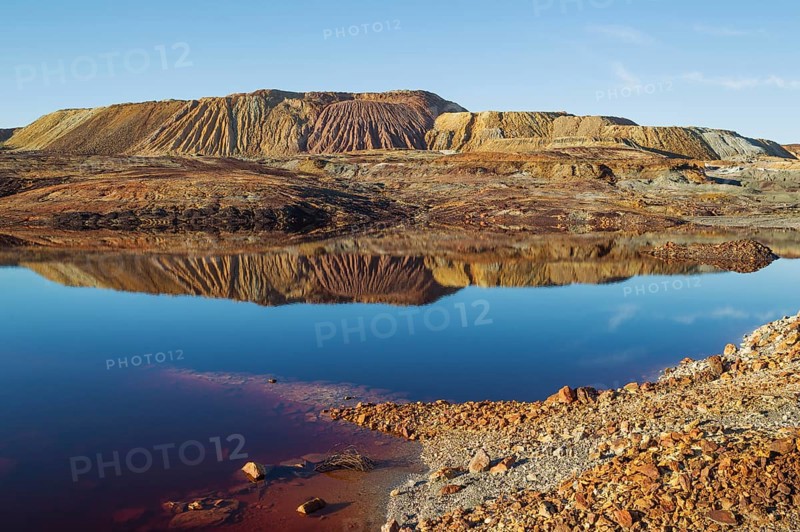 Mineral-rich ground and rocks with rainwater pool at Rio Tinto mines