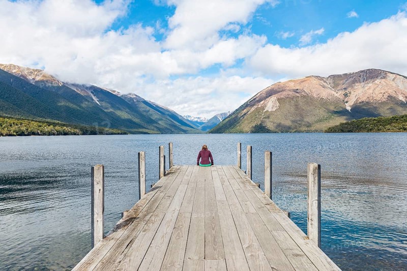 Woman sitting on dock