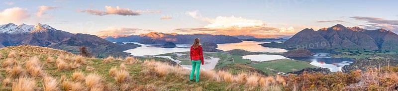 Hiker overlooking Lake Wanaka and mountains