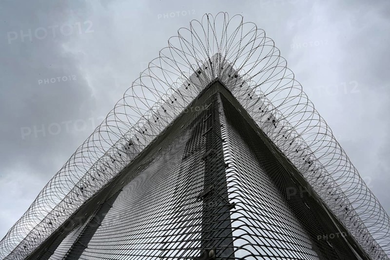 Security fence with barbed wire