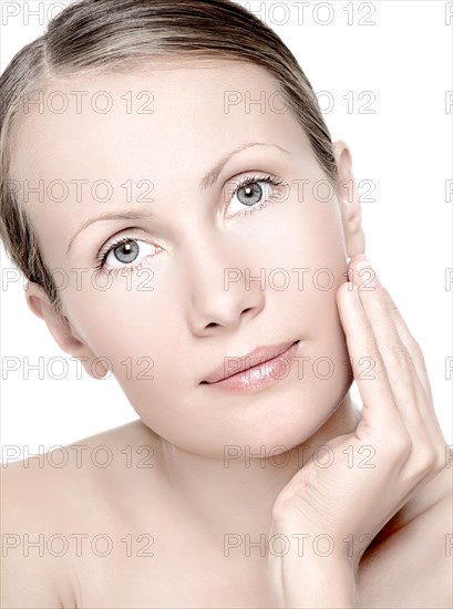 Young woman touching the cheek with her hand