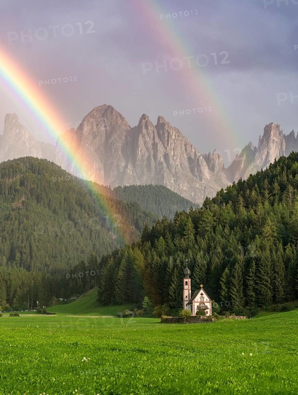 Rainbow in front of the church St. Johann in Ranui