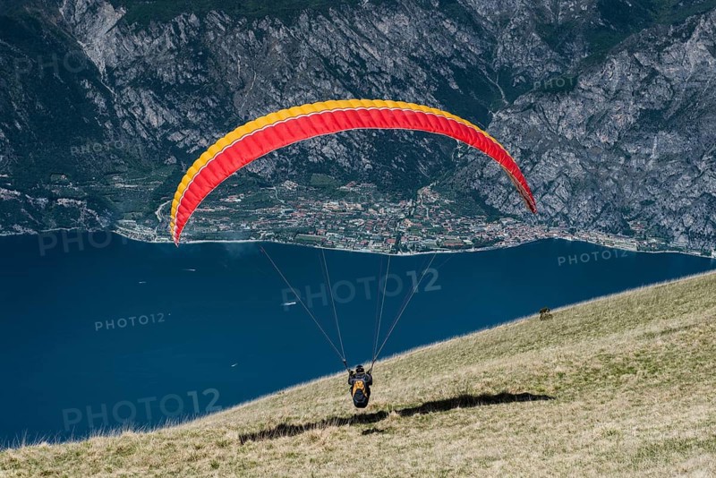 Paraglider at Monte Baldo over Lake Garda with Limone