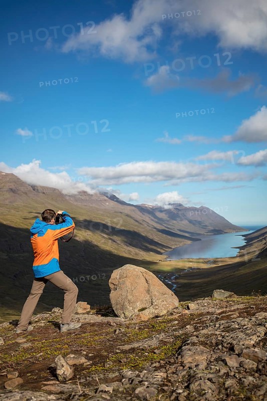 Photographer photographs view from Mjoafjaroarheioi Pass onto Mjoifjorour Fjord