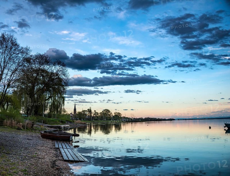 Rowboats by the lake at sunset