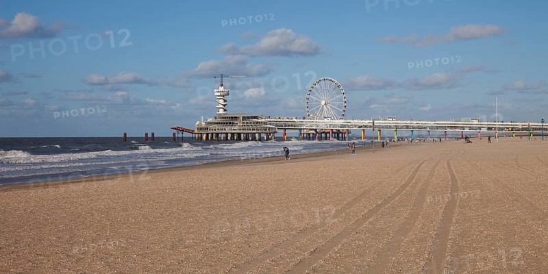 Pier with bungee jumping tower and Ferris wheel