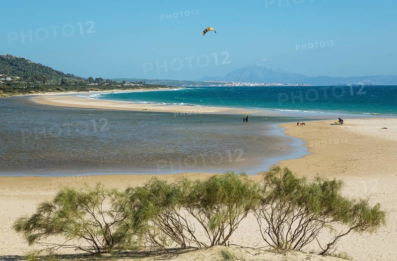 Sandy beach with hang glider at Bay of Valdevaqueros