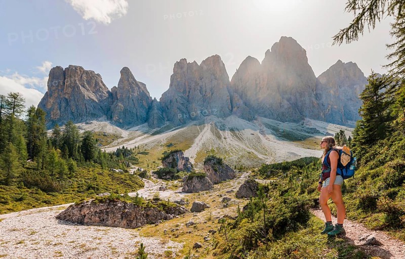 Hiking on footpath to the Geisleralm in the Villnos valley below the Geisler Peaks