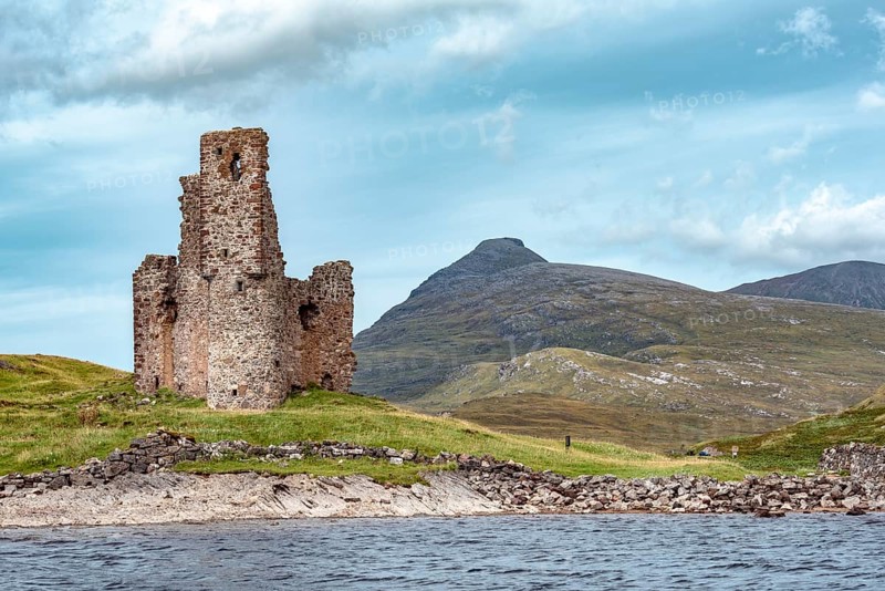 Castle ruin Ardvreck Castle on a peninsula by lake Loch Assynt