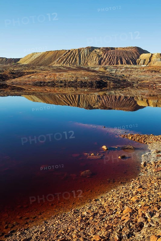 Mineral-rich ground and rocks with rainwater pool at Rio Tinto mines
