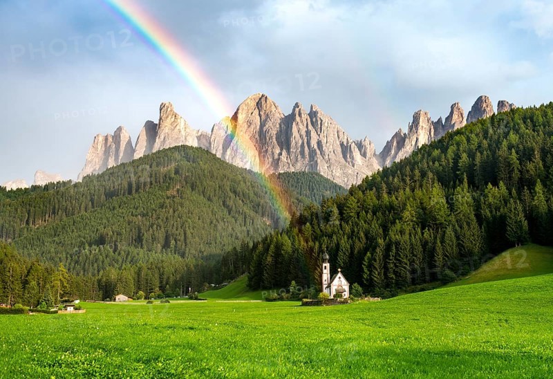 Rainbow in front of the church St. Johann in Ranui