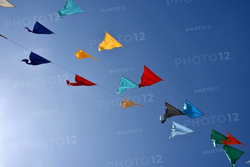 Colorful pennant against a blue sky at a festival