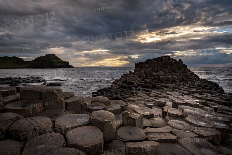 Basalt columns by the coast at sunset