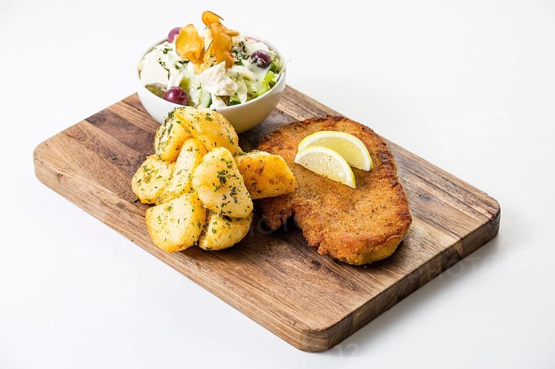 Breaded chicken escalope with buttered potatoes and a small salad