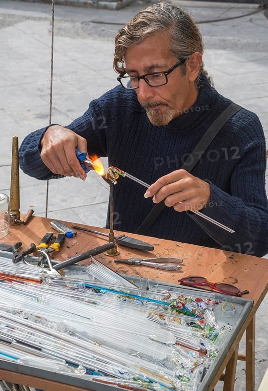 Man creating glass jewelry