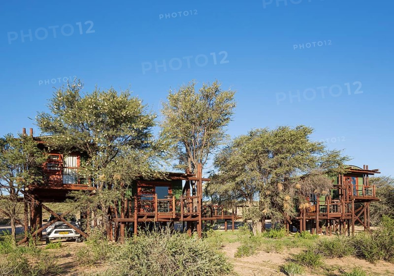 Urikaarus Wilderness Camp with stilt cabins at bank of dry Auob riverbed