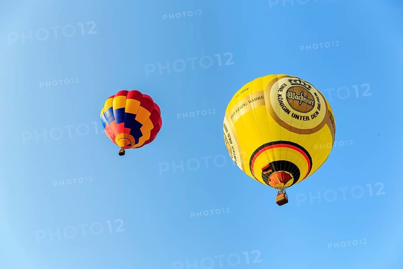 Two hot air balloons rising into the air