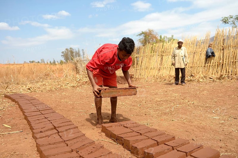 Teenager manufacturing bricks